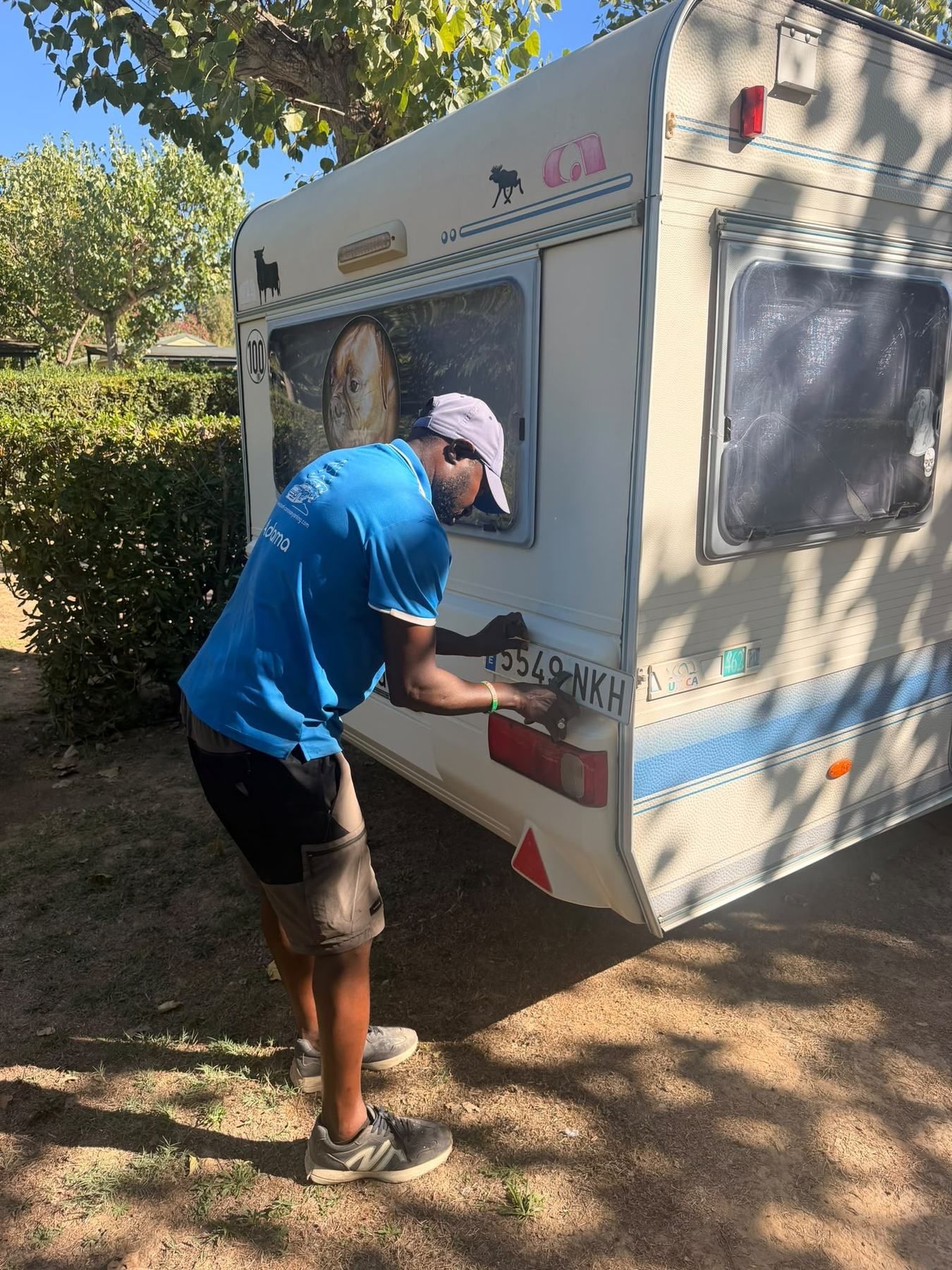 Technician working on the rear light board of a caravan