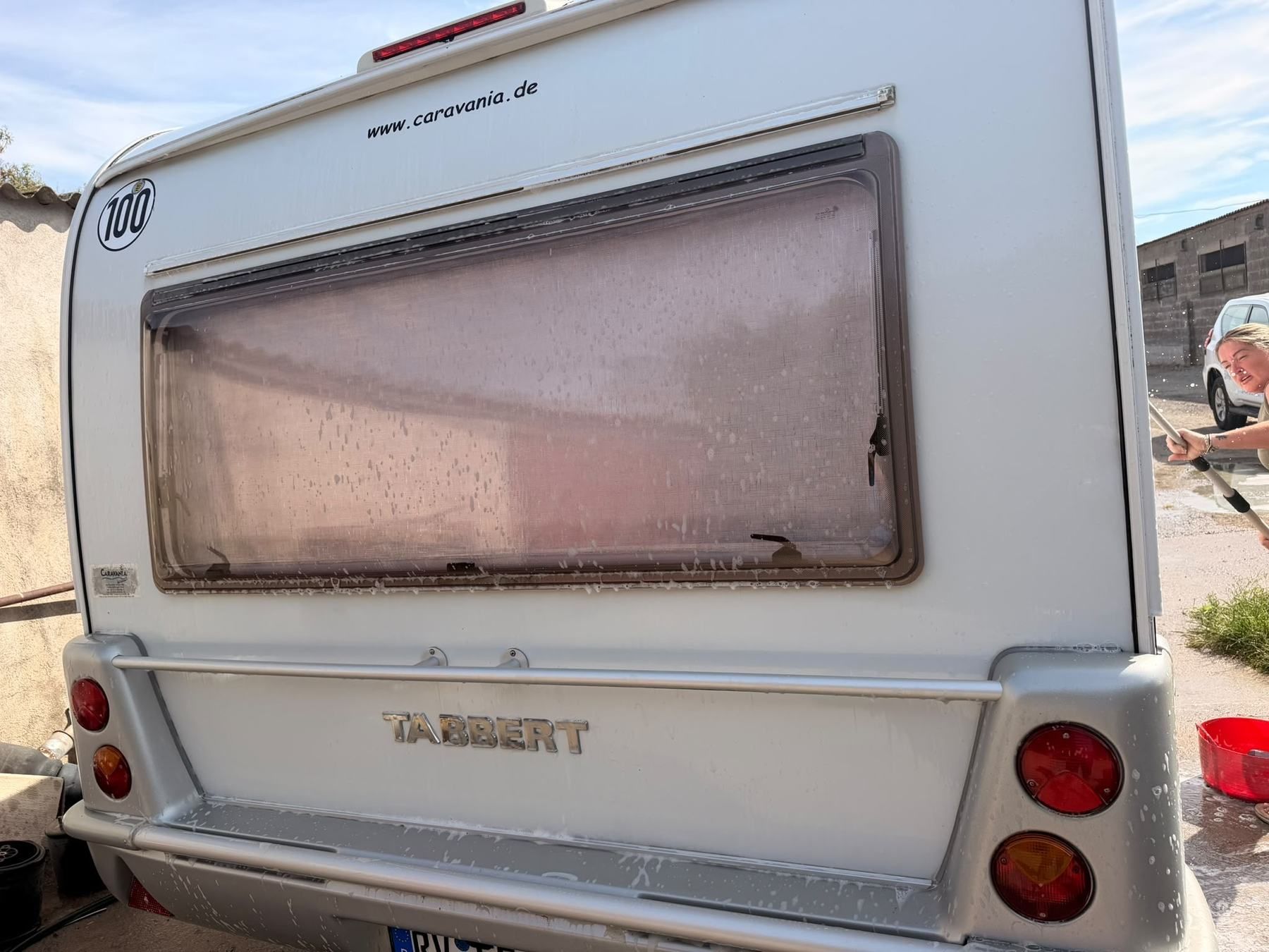 Rear of a Tabbert caravan during a wash