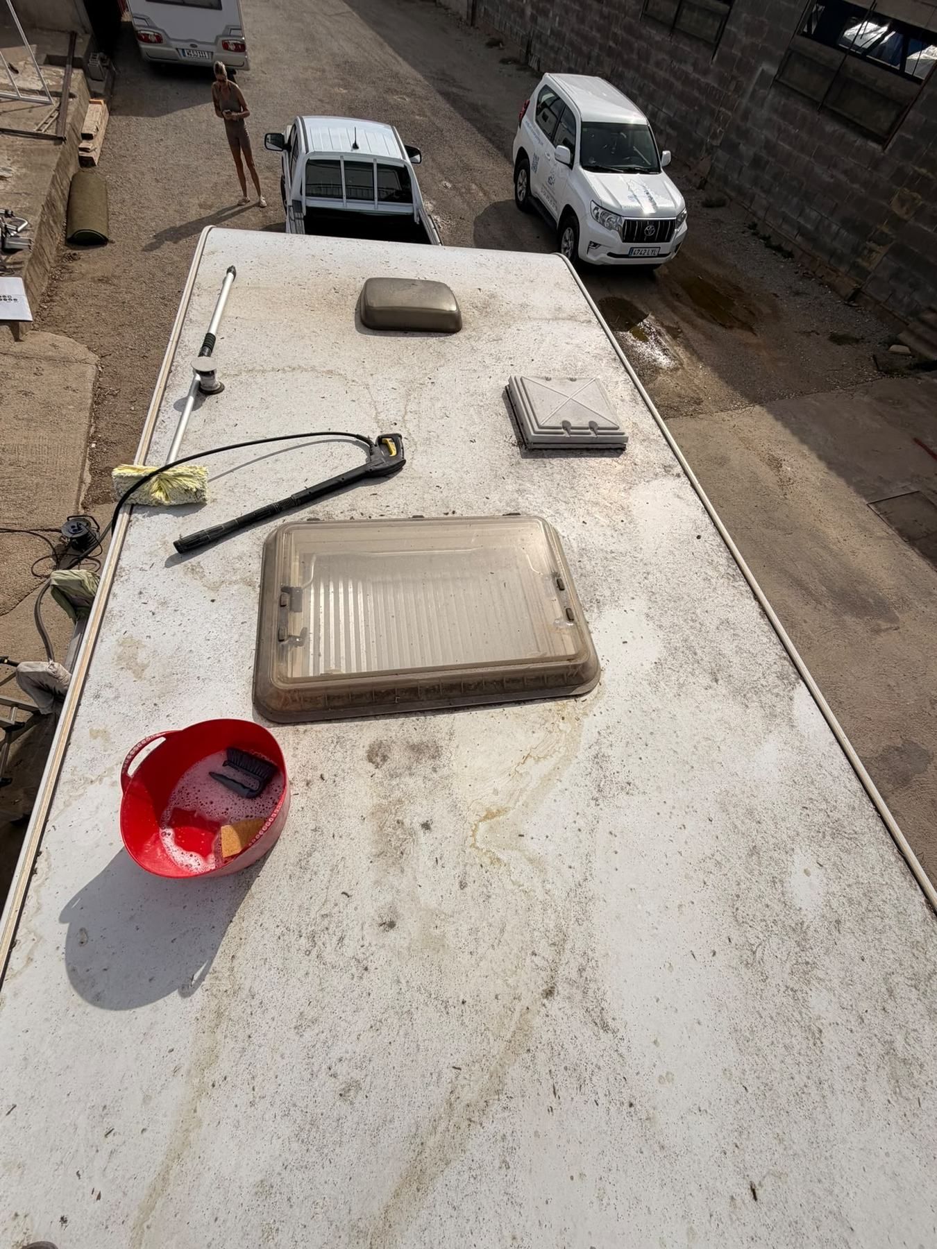 Caravan roof with skylights being cleaned, seen from above