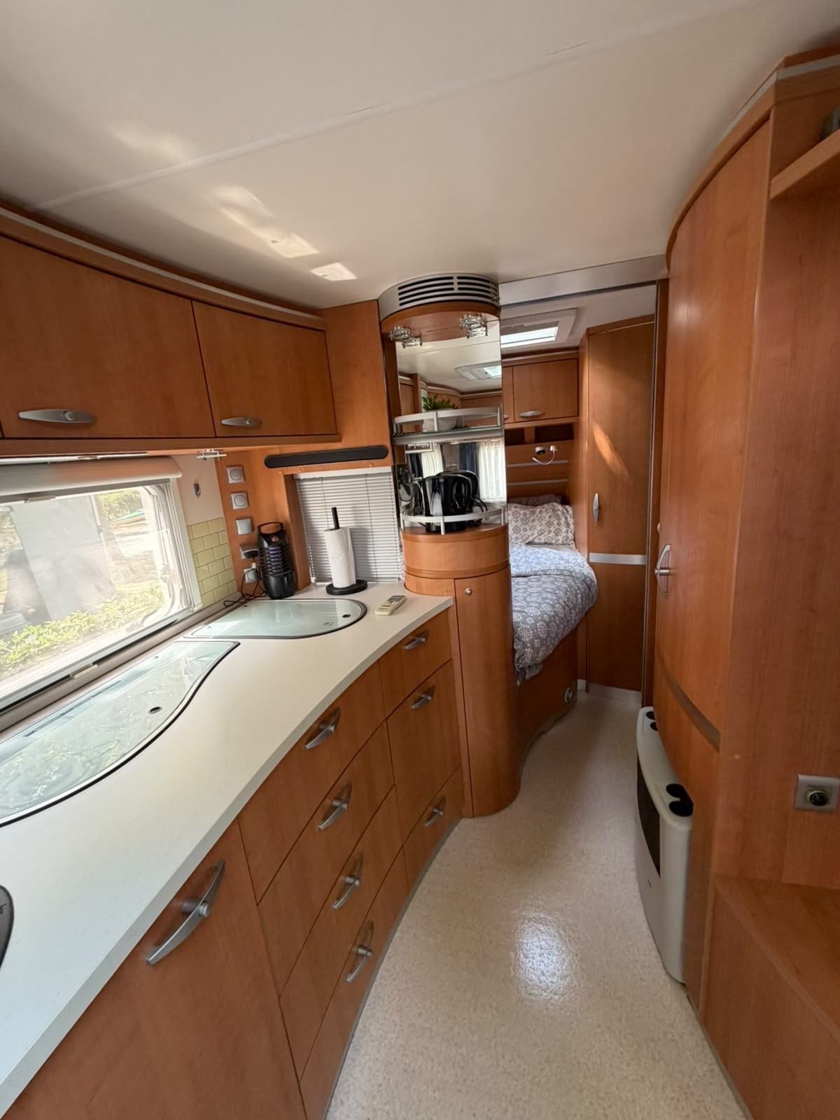 Caravan kitchen worktop leading to the rear bedroom
