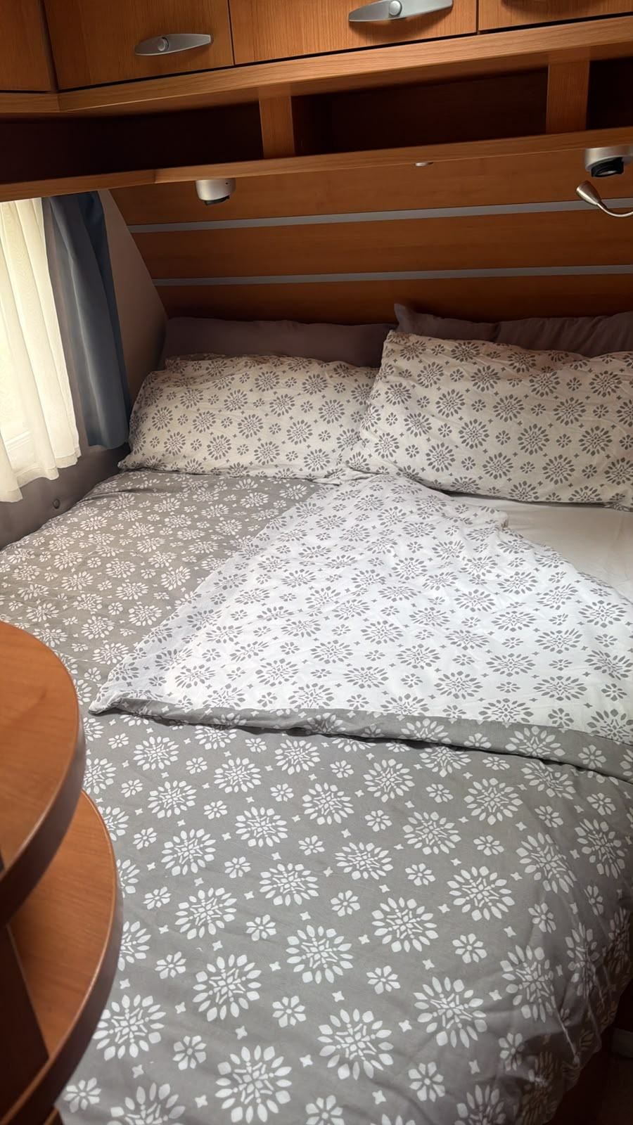 Double bed with patterned covers in a caravan
