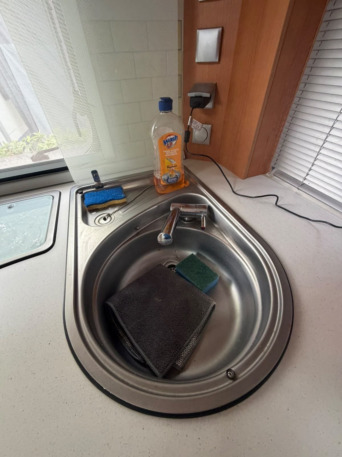 Round stainless steel sink in a caravan kitchen