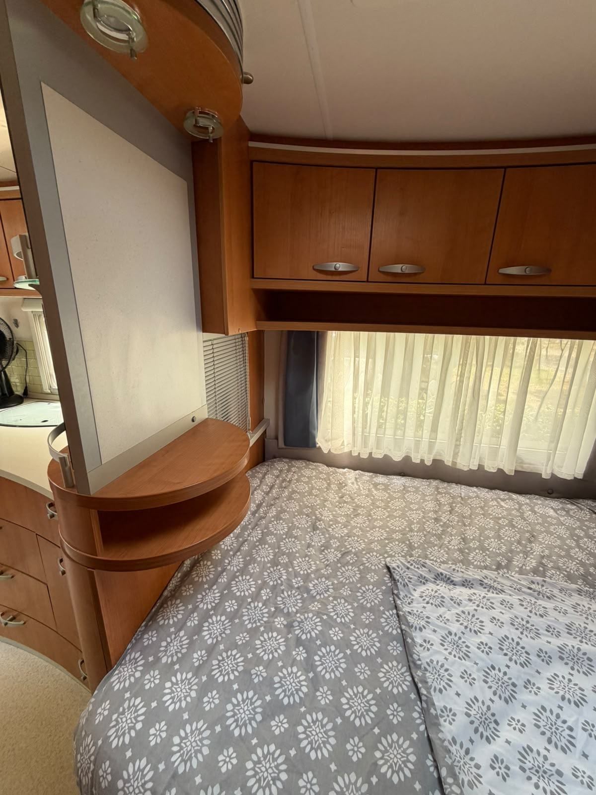 Caravan bedroom with overhead lockers