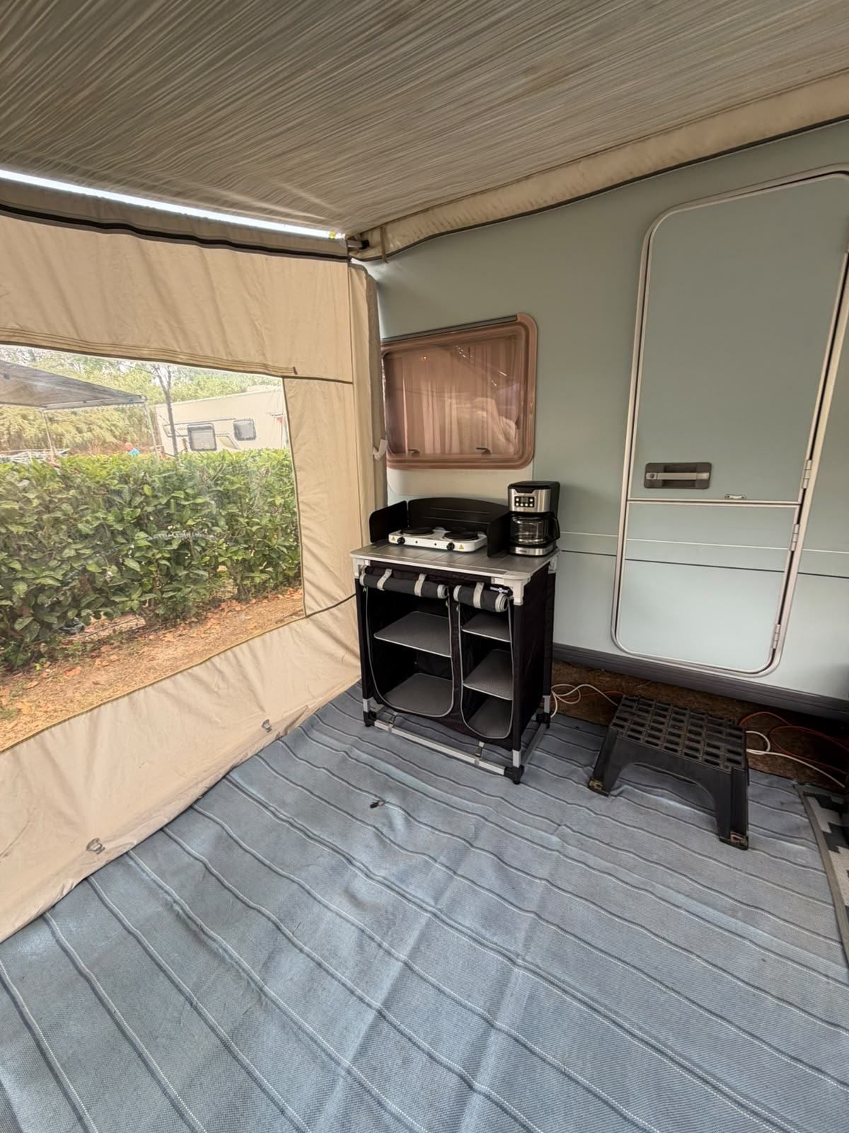 Inside an awning with a cooking unit and groundsheet