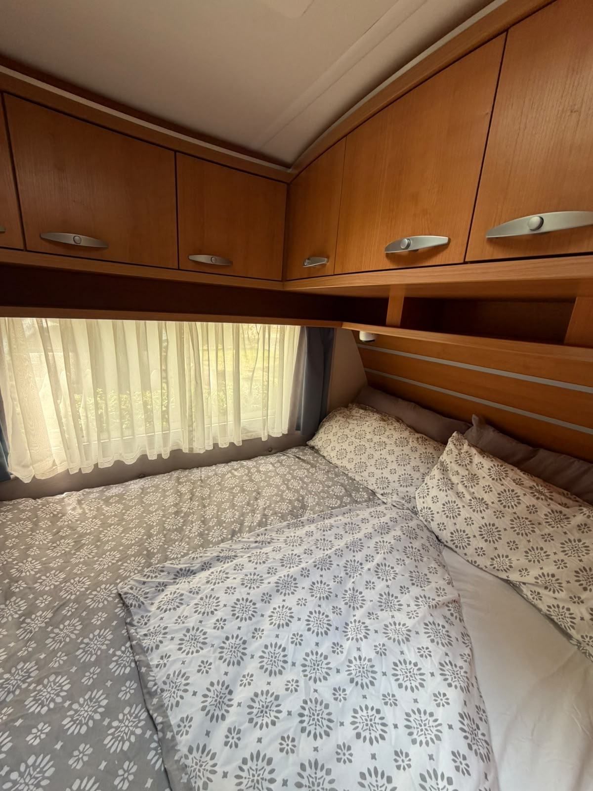 Caravan double bed under overhead lockers