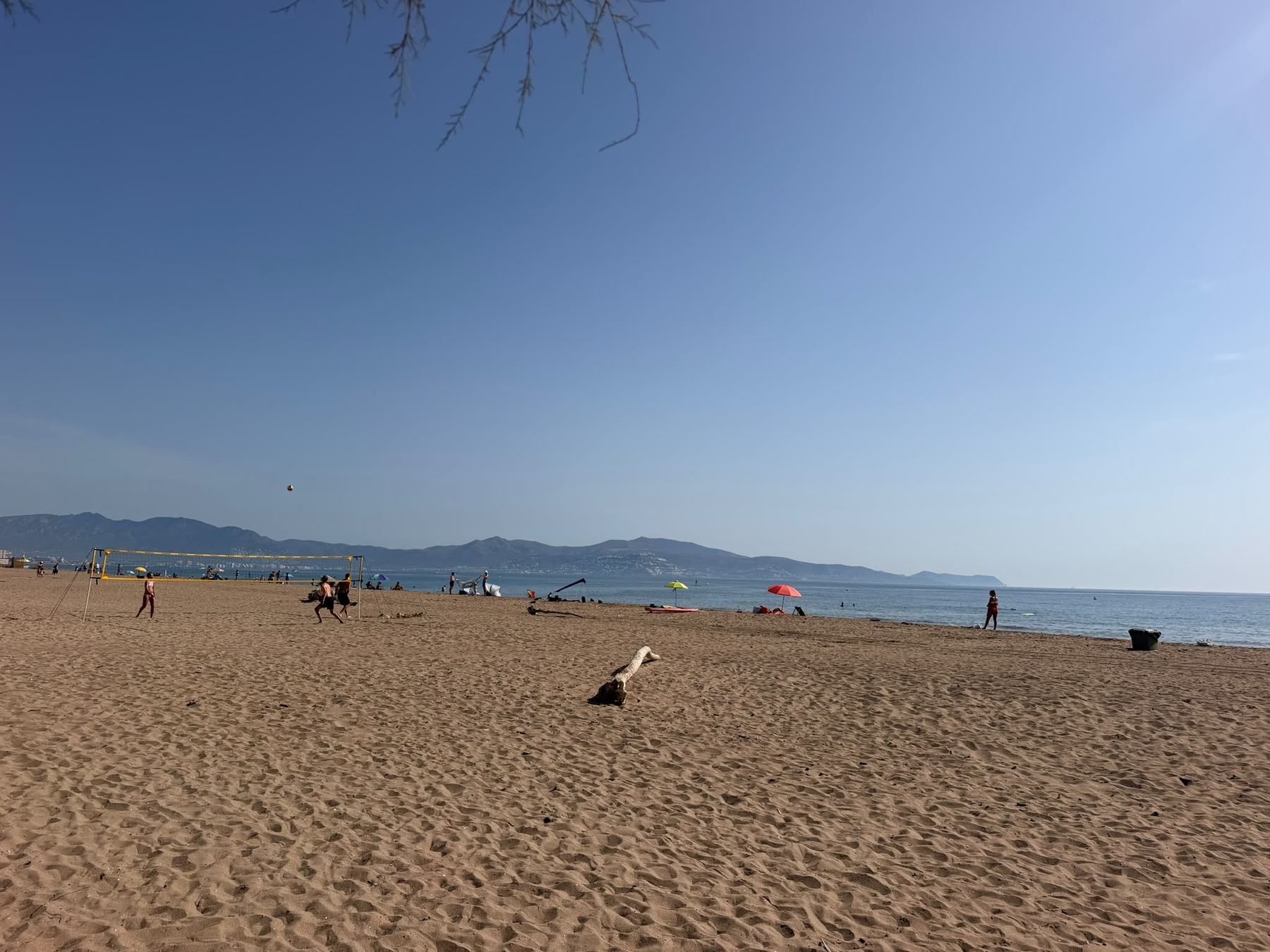 Sandy Costa Brava beach with mountains across the bay