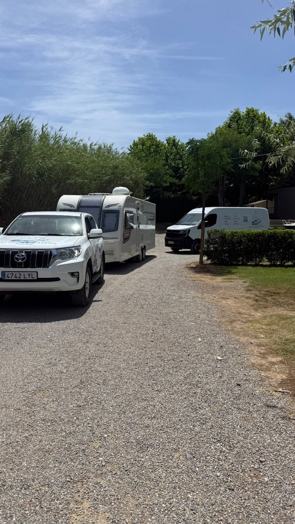 Punt Caravan Parking 4x4 towing a caravan along a gravel campsite lane