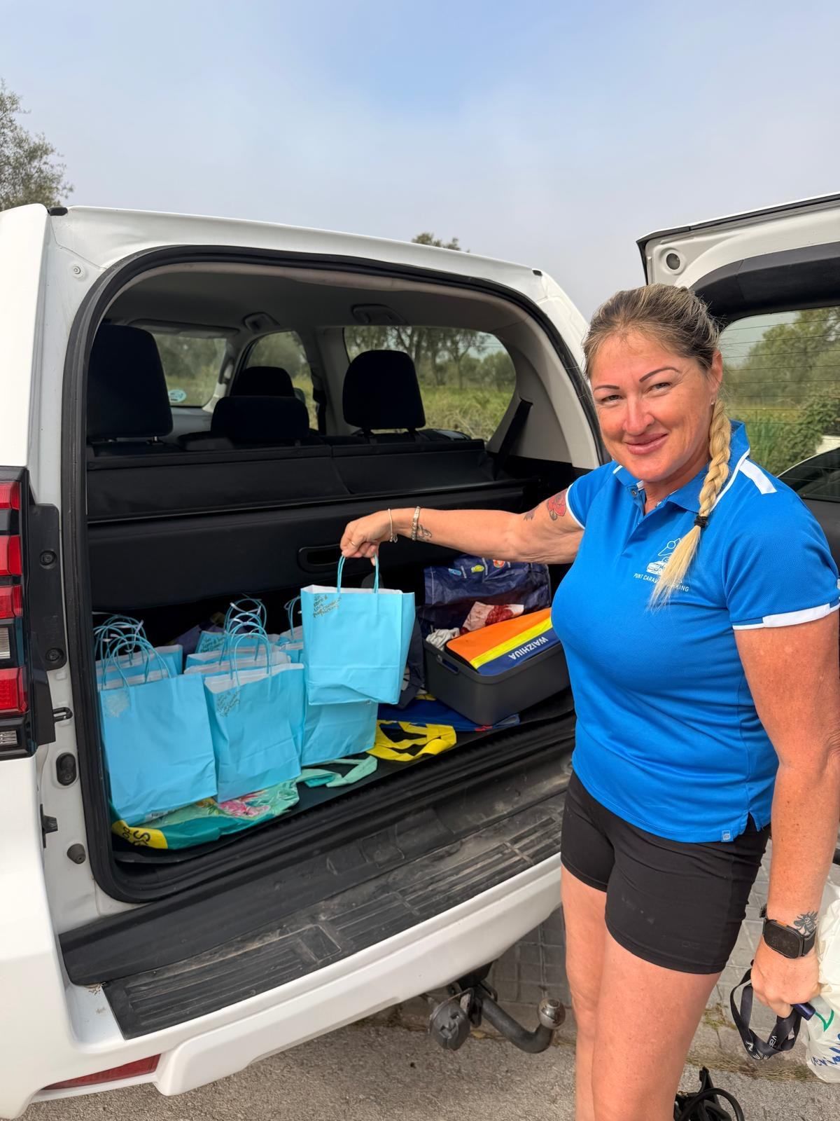 Team member with gift bags in the boot of the Punt car