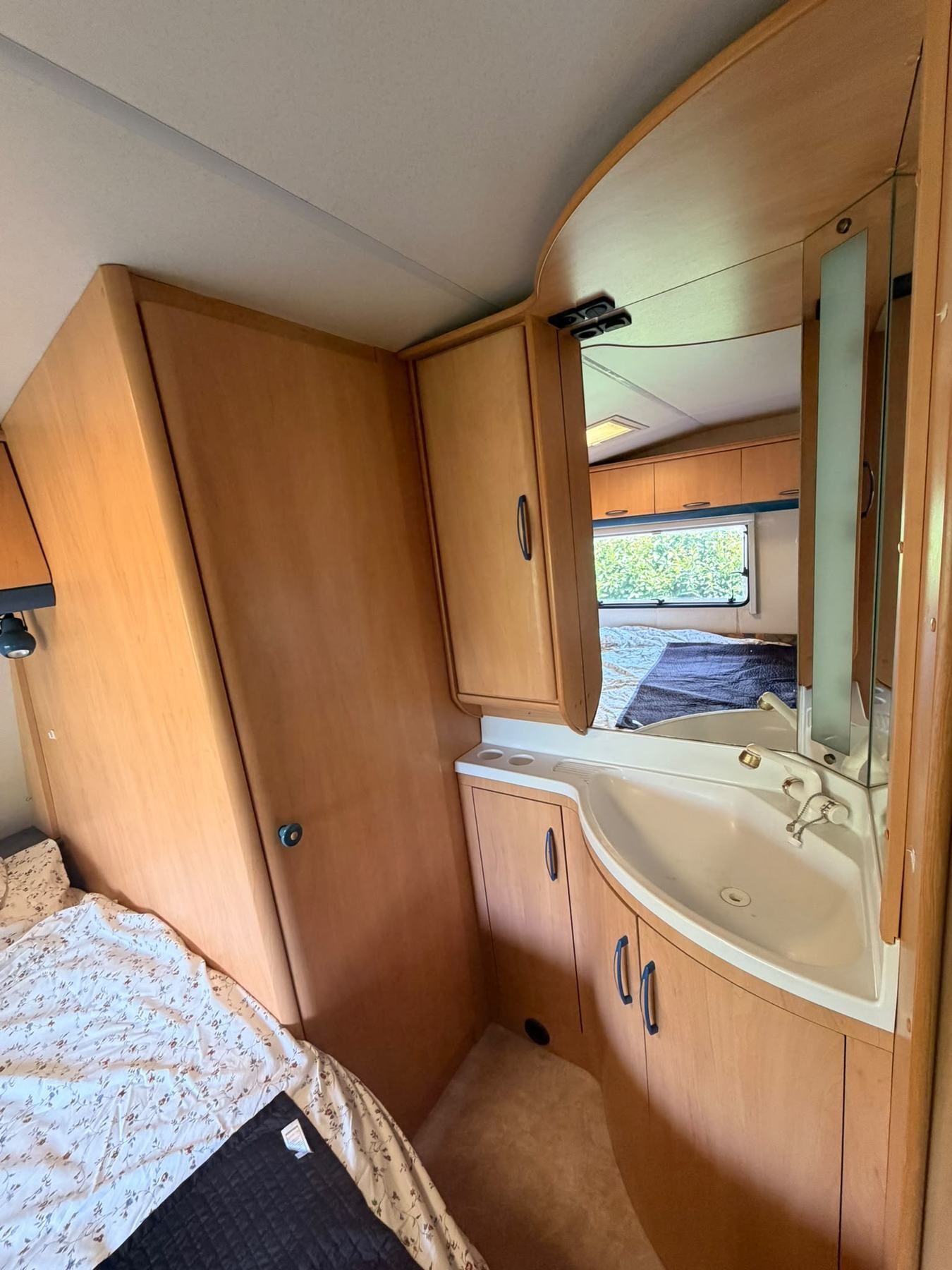 Caravan washroom with a corner basin and mirror
